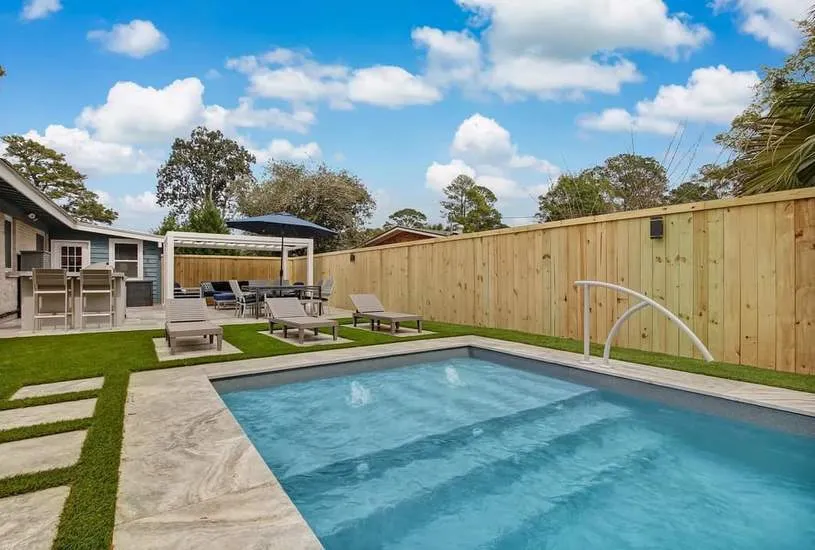 A luxurious pool and spa combination featuring a cascading waterfall.