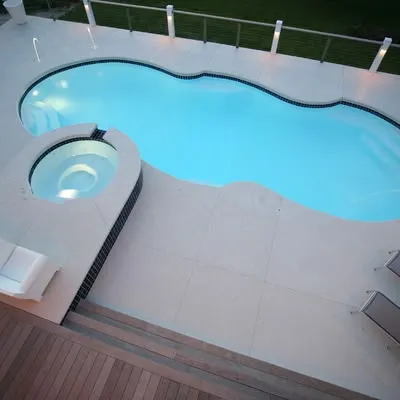 Close-up of a sparkling blue pool finish with a built-in tanning ledge.