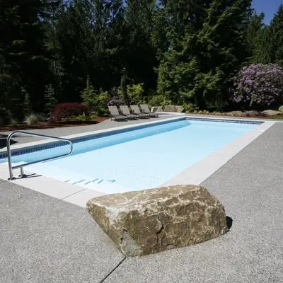 A complete backyard oasis with a pool cage and comfortable lounge furniture.